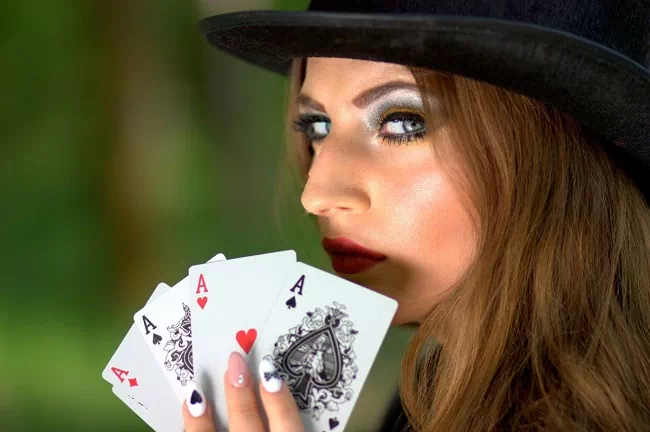 5 Card Draw is an easy to grasp format Woman holding four aces